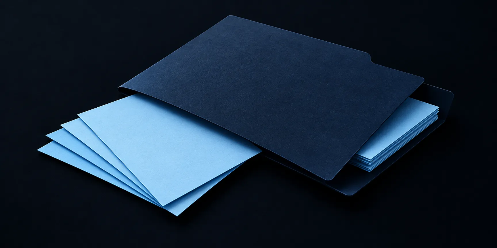 Blank pale-blue paper sheets fan out beneath a navy folder, with another slim stack partly inside.