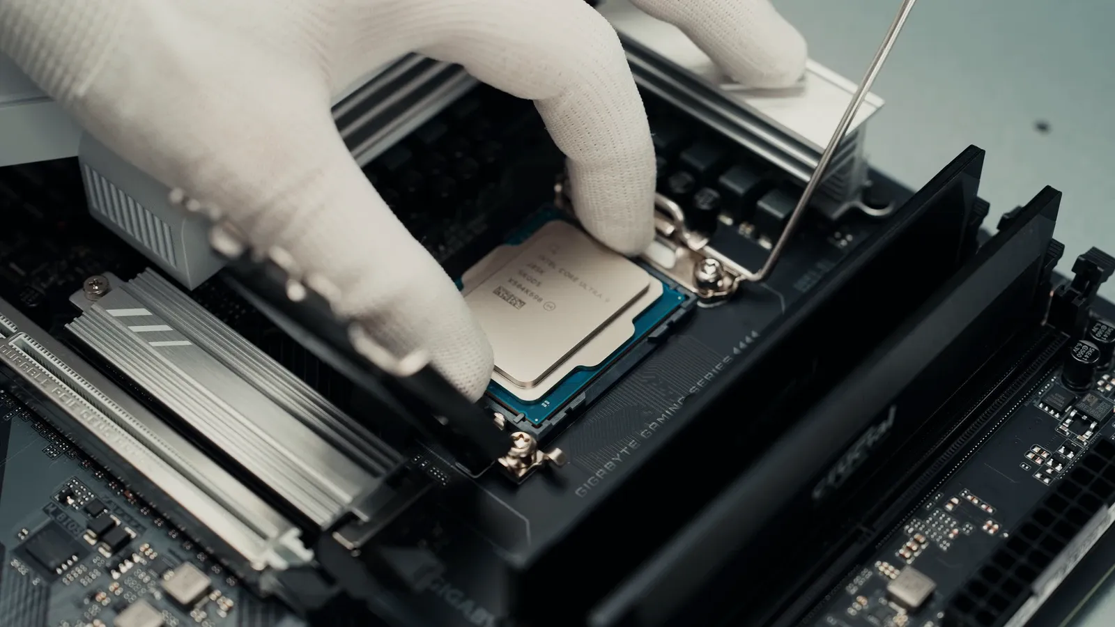 A gloved hand installing a processor in a VYKIX server.