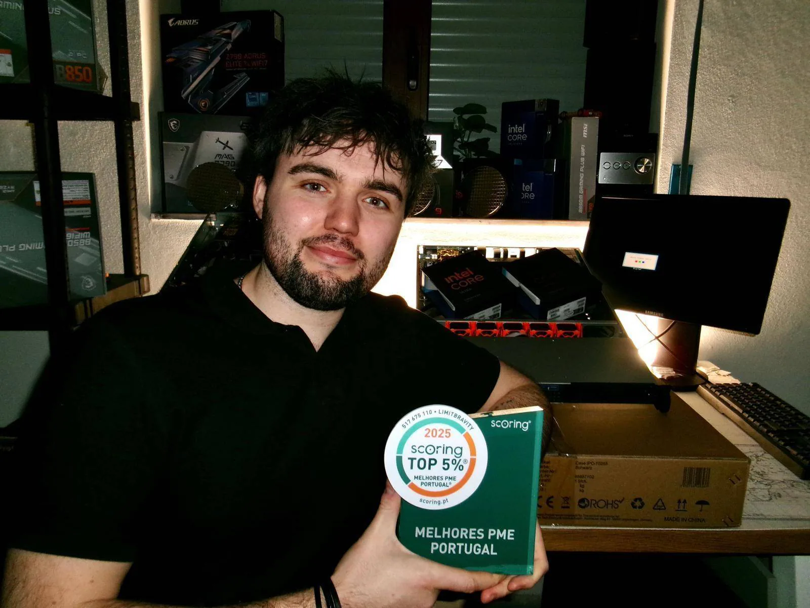 VYKIX founder and CEO beside server hardware, holding a Portuguese business award.